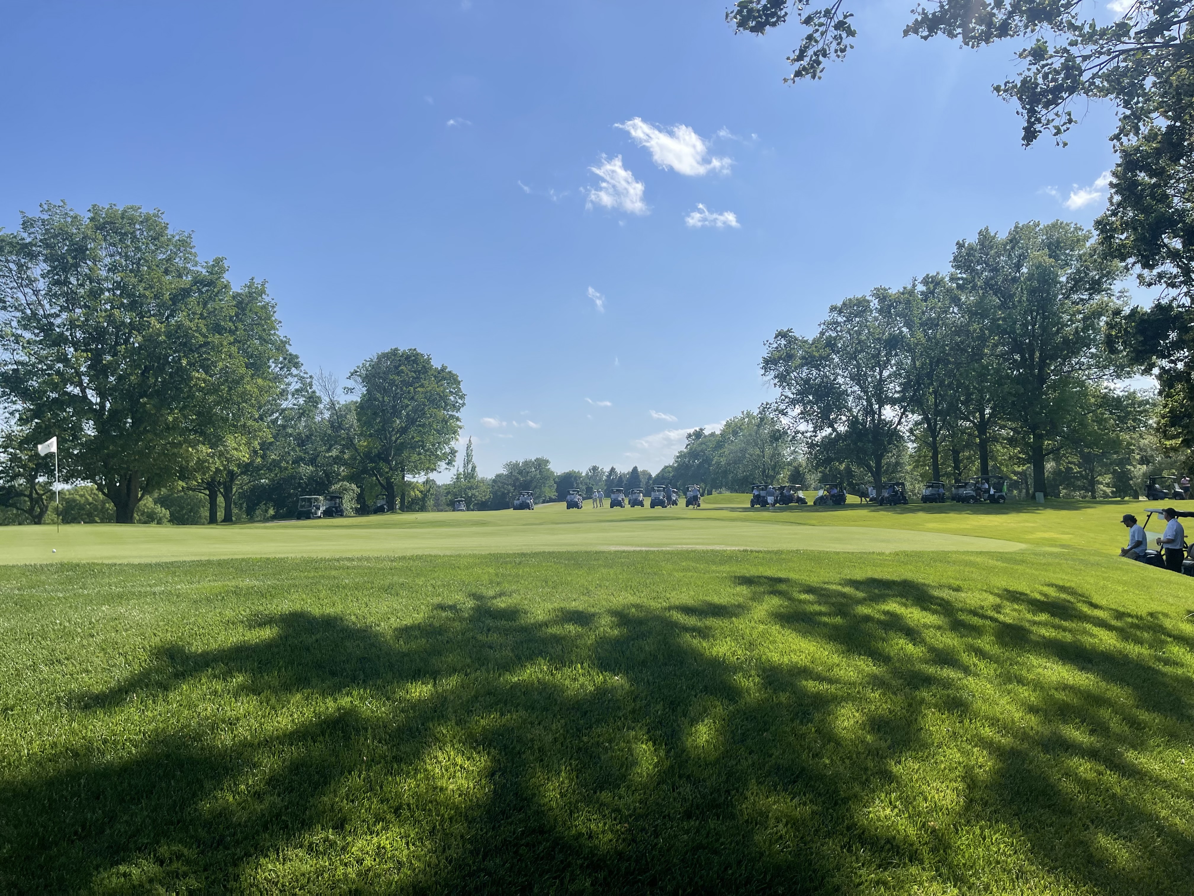 A group teeing off on a sunny morning