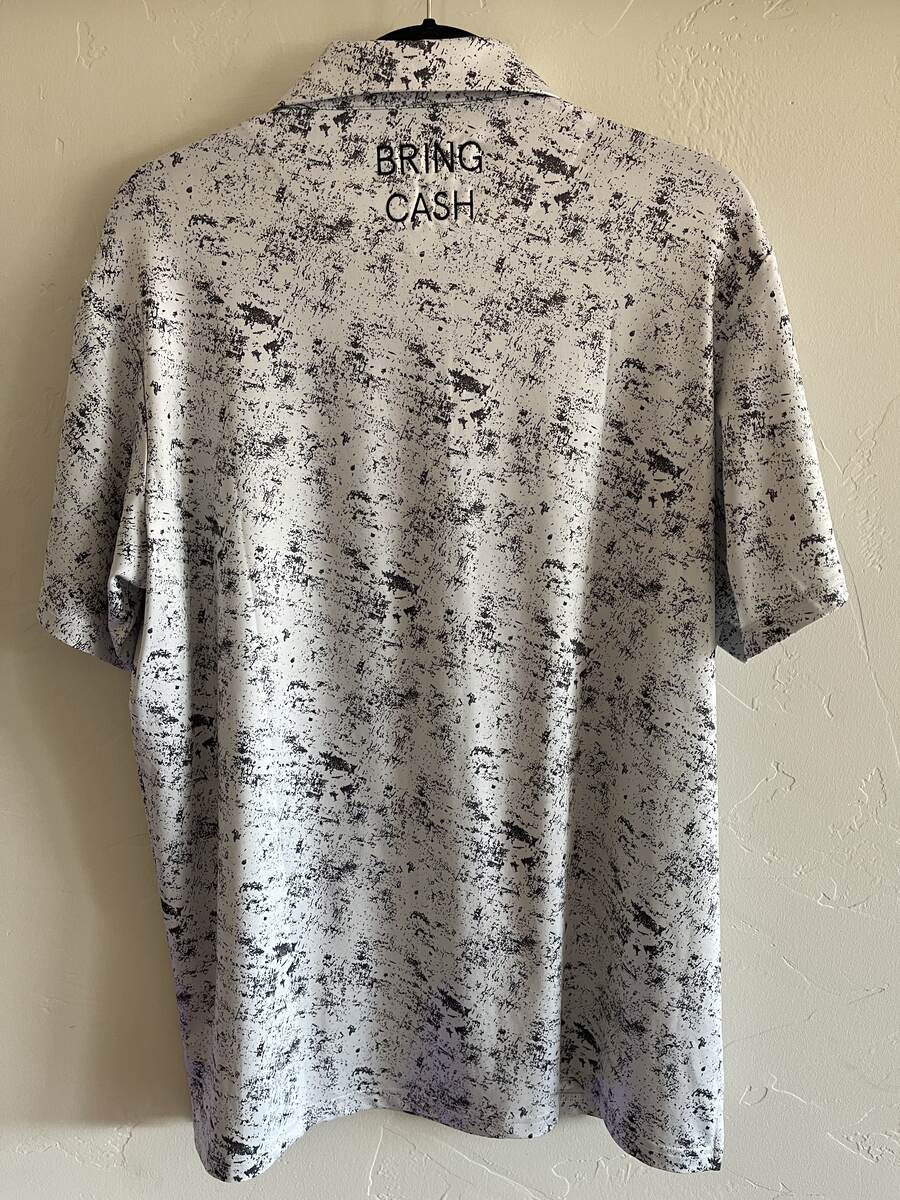 White paint-splatter Duck Hook Golf performance polo, back with BRING CASH embroidery