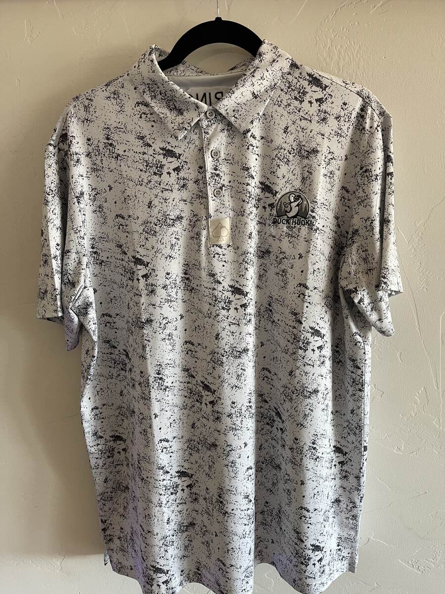 White paint-splatter Duck Hook Golf performance polo, front with embroidered logo